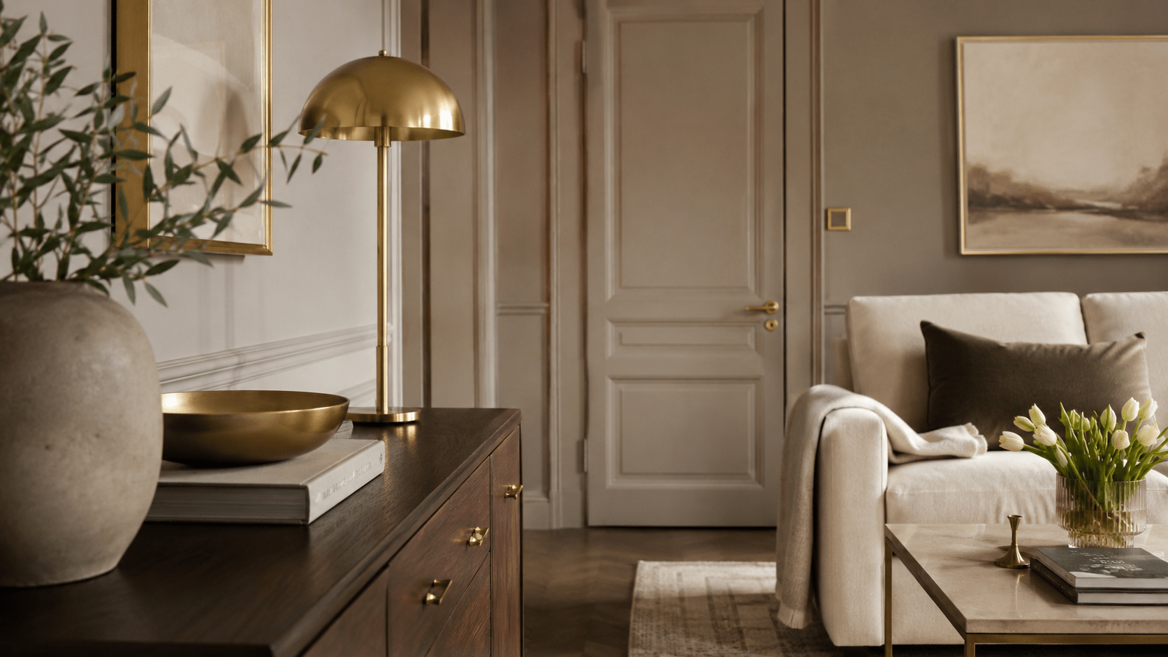 Elegantes Wohnzimmer mit wiederholten Messingdetails, dunklem Holz und warmen Naturtönen.